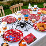 Table setting demonstration with Grencian spider party decorations