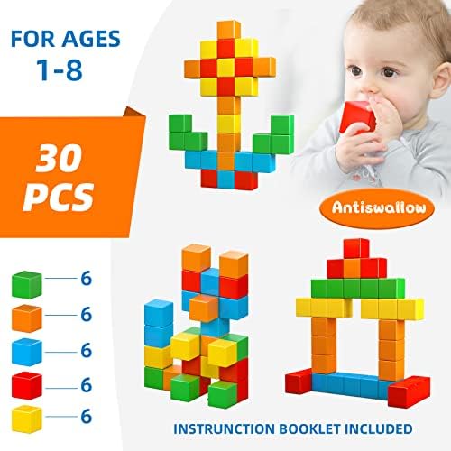 Toddlers playing cooperatively with bright color building blocks on a clean play mat