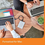 WD 5 Terabyte My Passport Ultra for Mac premium silver portable drive next to a laptop