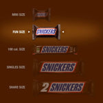 Snickers Original Fun Size bite-sized candies filling up a transparent glass snack bowl for party hosting.