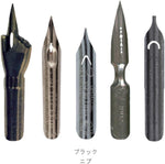 Wooden pen holder and steel writing nibs included in the Herbin gift box.