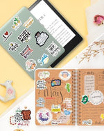Oomloid scrapbook accessories spread out to show variety of designs