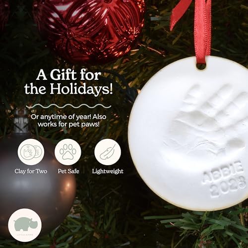Finished baby handprint ornament displayed on a wooden tabletop easel