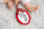 Close up of the non toxic infant impression kit with imprint cards and red wooden frame