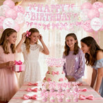 Coquette birthday party supplies including hanging swirls and balloons