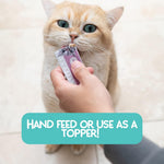 Human hand feeding cat with Love Nala squeeze tube