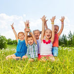 Child and adult wearing BuggyBands mosquito repellent bands