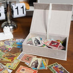 Stack of Hiwhy beige linen photo organizer boxes on a desk