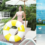 Lifestyle shot of striped pool floats at a summer party