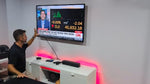 OREI high-bandwidth signal converter functioning in a modern home theater setup with indicator lights illuminated