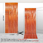 Close up view of the shimmering orange metallic foil material texture.