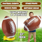 Large 36 inch brown inflatable football centerpiece being used as a fun photo prop.