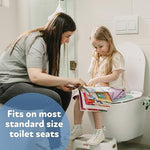 Compact travel toilet seat trainer being placed into a diaper bag