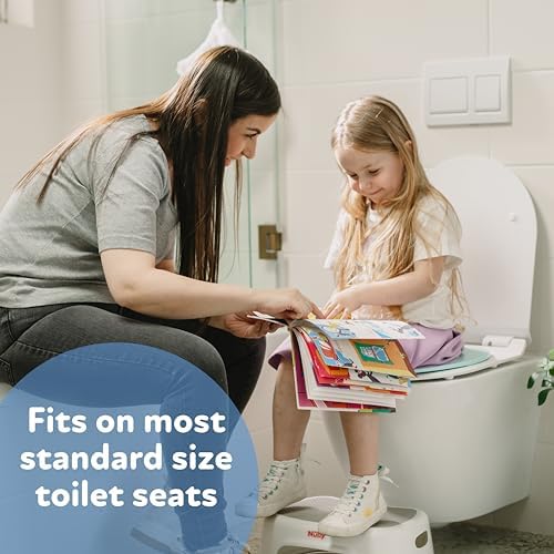 Compact travel toilet seat trainer being placed into a diaper bag