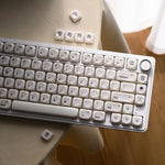 OHY white chocolate minimalist Mac style keycaps close up focusing on smooth ceramic finish