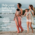 Mother using Nalakai ring sling baby carrier for front carrying
