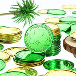 Two hundred pieces of green and gold holiday tokens laid out in an even distribution.