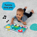 Infant lying on their stomach during tummy time interacting with the colorful lights of the Baby Einstein musical learning mat.
