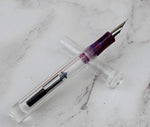 Marbled celluloid grip section on clear acrylic pocket pen