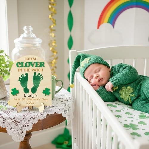 Instructional view of stamping a newborn baby foot onto the green clover keepsake board