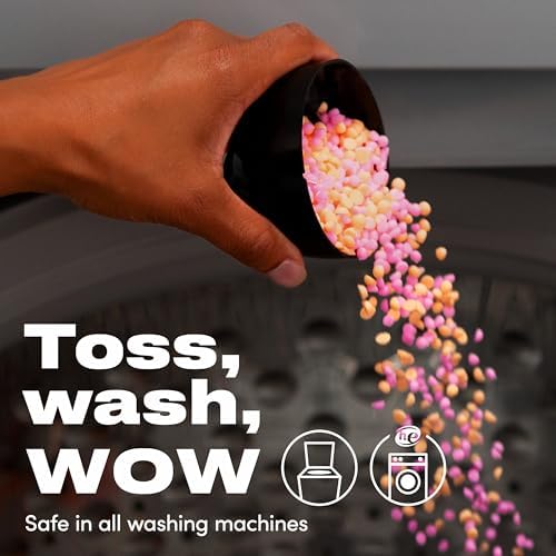Large 21.1 Ounce container of Downy Unstopables Fusions on a laundry room shelf.