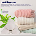 Applying essential oil drops onto a reusable wool dryer ball for scented laundry.
