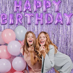 Graduation party stage setting using light purple metallic streamer backdrops