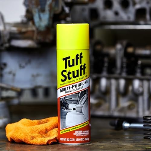Angled view of the Tuff Stuff car upholstery cleaner canister highlighting the multi surface application icons for fabric vinyl and carpet.