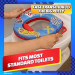 Hot Wheels toddler toilet seat hanging neatly on a bathroom wall using the included storage hook.