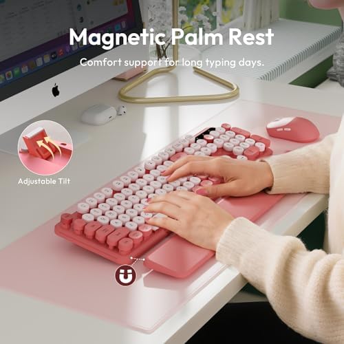 Cute pink wireless mouse with adjustable DPI tracking levels beside round keycaps