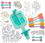 Turquoise plastic bracelet maker loom showing colorful threads attached for DIY macrame and wrapped jewelry patterns.