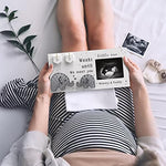 Close-up view of the handmade cotton string art elephants on the pregnancy countdown frame.