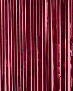 Glitch free party decorations showing the top header adhesive strip of the metallic tinsel backdrop