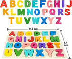 Toddler hands holding a bright blue wooden letter block over the matching slot on the board.