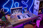 Wiping the reusable acrylic surface of the Crayola ultimate light board clean with a damp cloth.