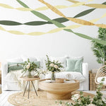 Kiwayo elegant wedding party decorations featuring twisted crepe paper garlands along a rustic wall.