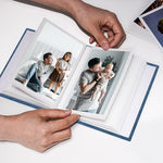 Vienrose small pocket album being placed into a travel bag as a portable brag book.