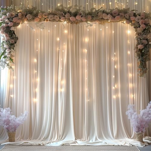 Two panels of ivory fabric drapes hanging beautifully on an event arch stand