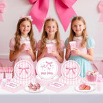 Pink bow birthday party table setup for girls