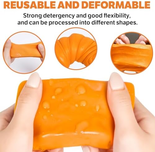 Close up of orange premium grade magic clay bar removing overspray and tree sap from vehicle paint.