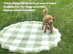 Brooklyn Neutral green gingham check splash pad laid out flat on a patio surface