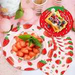 Close up of OuMuaMua strawberry themed paper plates and napkins