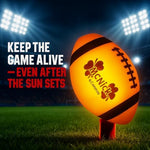 MCNICK & COMPANY impact activated LED football illuminating upon being caught mid air during an evening game.