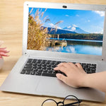 Ultra thin laptop camera cover slide applied next to a computer lens demonstrating minimal thickness.