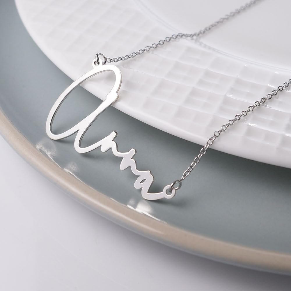 PicturesOnGold personalized script necklace laid flat on surface