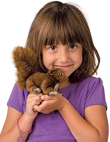 Folkmanis red squirrel wildlife puppet resting in the palm of a hand showing scale and portability.