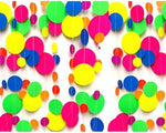 Lightweight neon paper streamers draped along a garden fence showing versatile outdoor event decorating options.