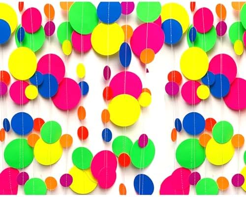 Lightweight neon paper streamers draped along a garden fence showing versatile outdoor event decorating options.