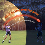 Impact activated LED light up football illuminating during a nighttime backyard catch game.