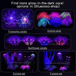A fully decorated fish tank landscape featuring the glowing purple Bluecoco silicone coral decoration.